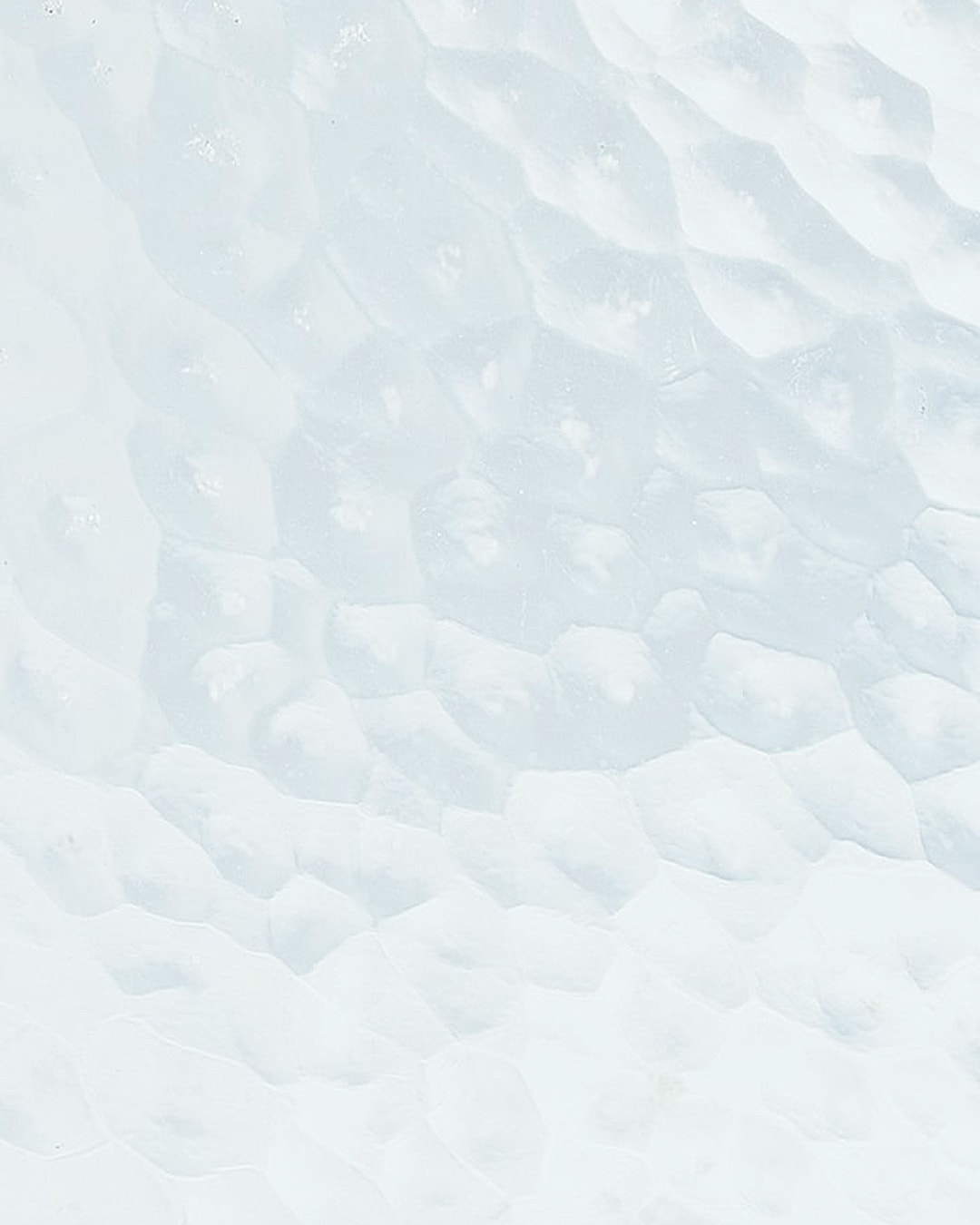 Textured white background with subtle hexagonal pattern