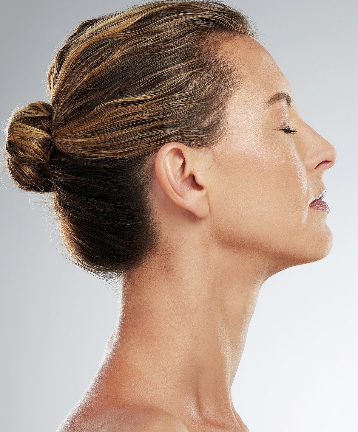 Man with styled hair looking sideways.