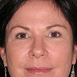 Close-up portrait of a woman with earrings.