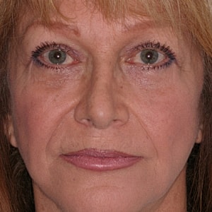 Close-up portrait of a woman with striking eyes.