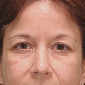 Close-up of a woman's face with brown eyes.