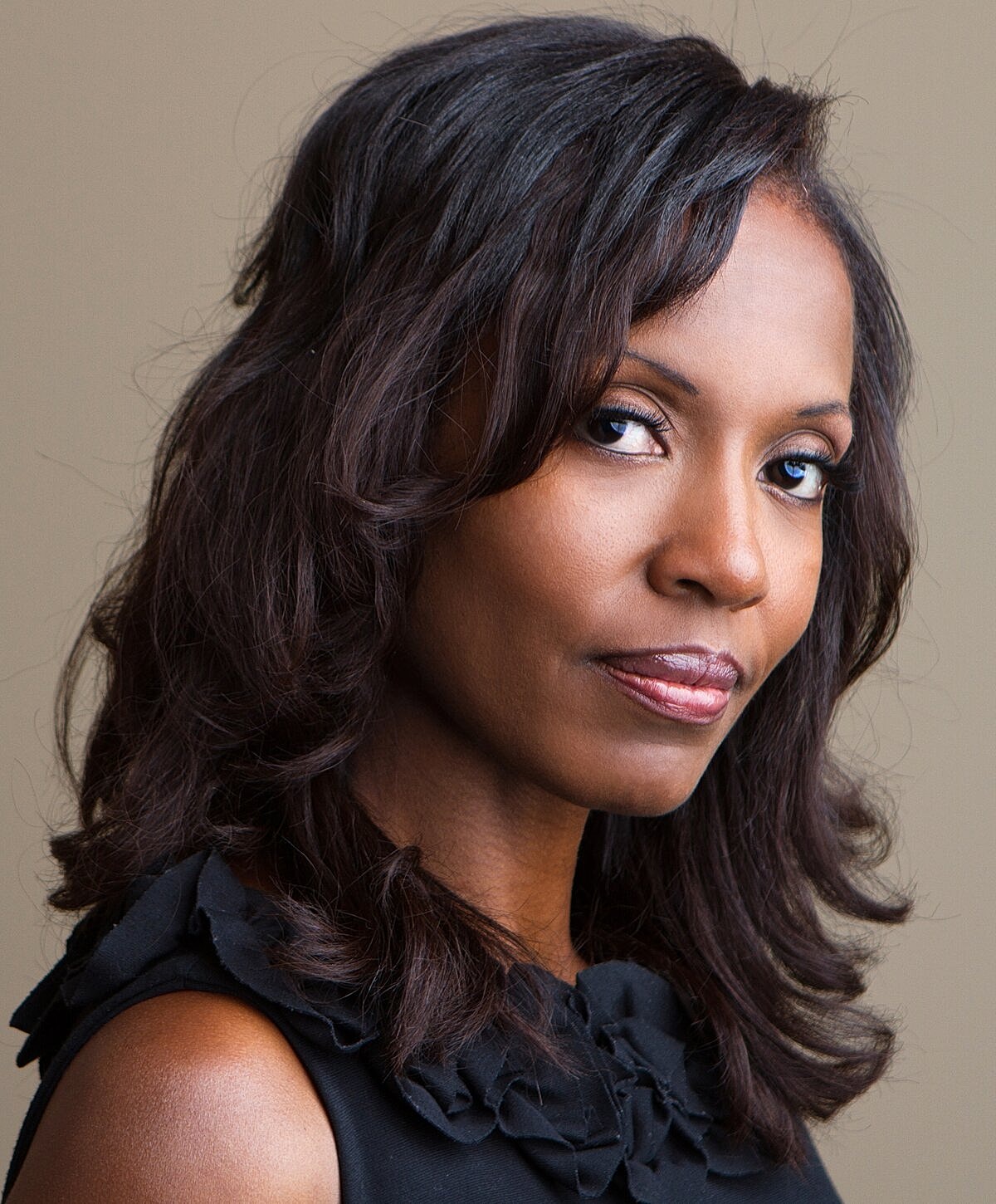 Portrait of a woman with long, wavy hair.