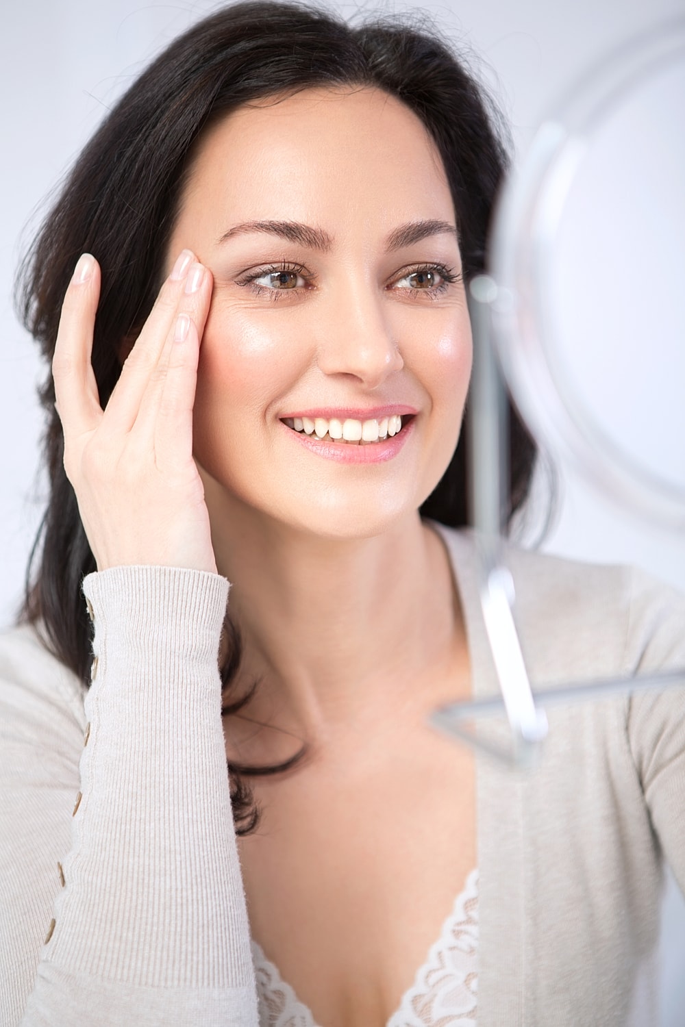 Woman reading document on a blue couch.