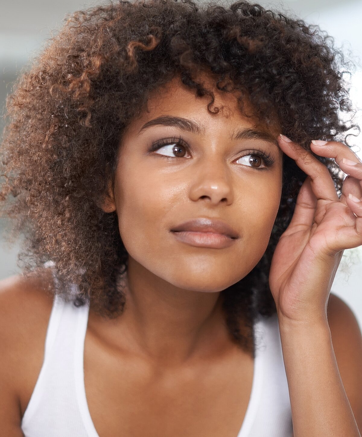 Woman reading document on a blue couch.