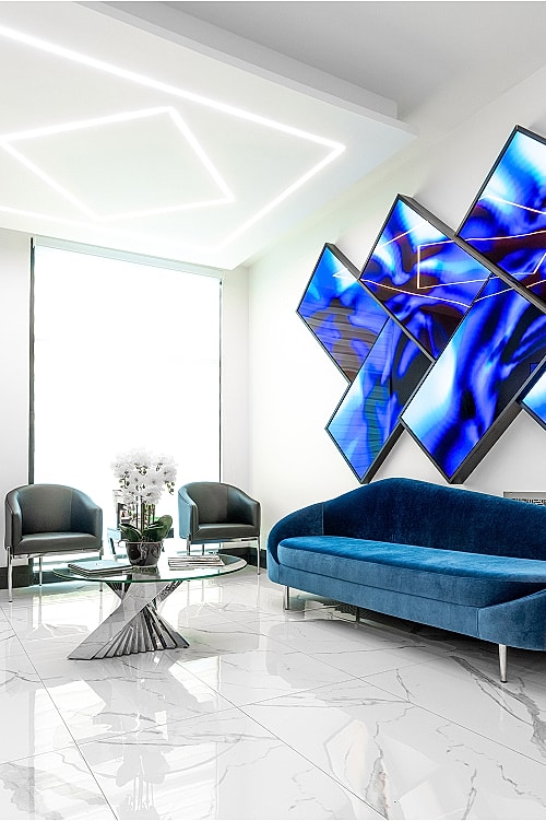 Modern interior with blue sofa and digital art.