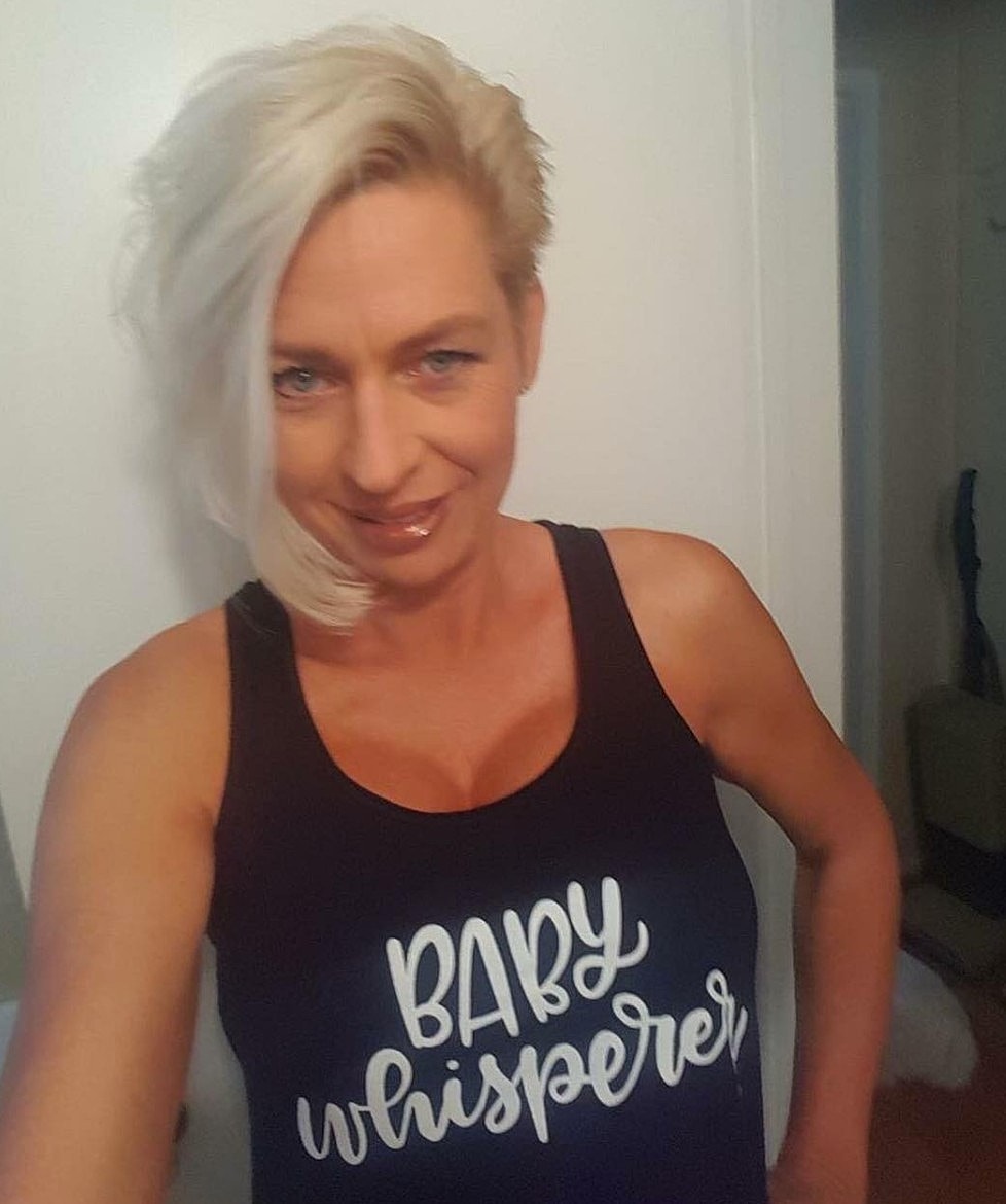 Woman wearing "Baby Whisperer" tank top selfie.