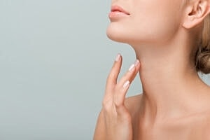 Woman touching her neck with soft lighting