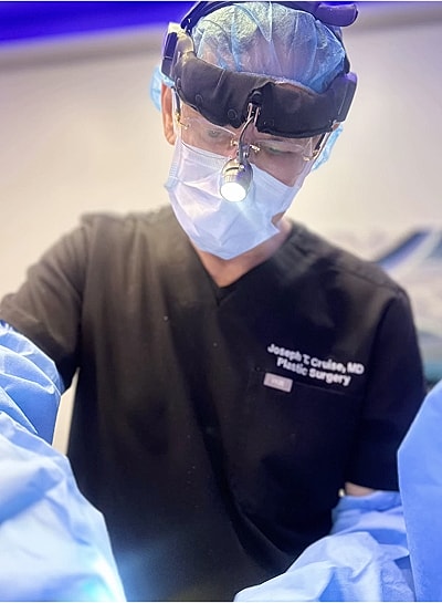 Surgeon performing a procedure in a sterile environment.
