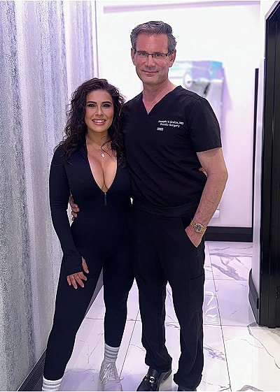 Two people posing in a medical office setting.