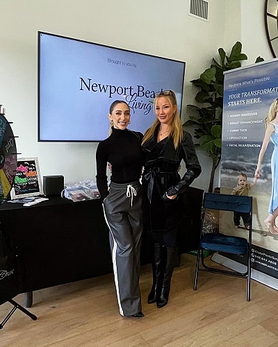Two women posing at Newport Beach Living event.