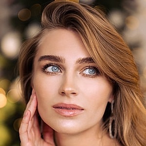 Makeup artist preparing a client for a photoshoot.