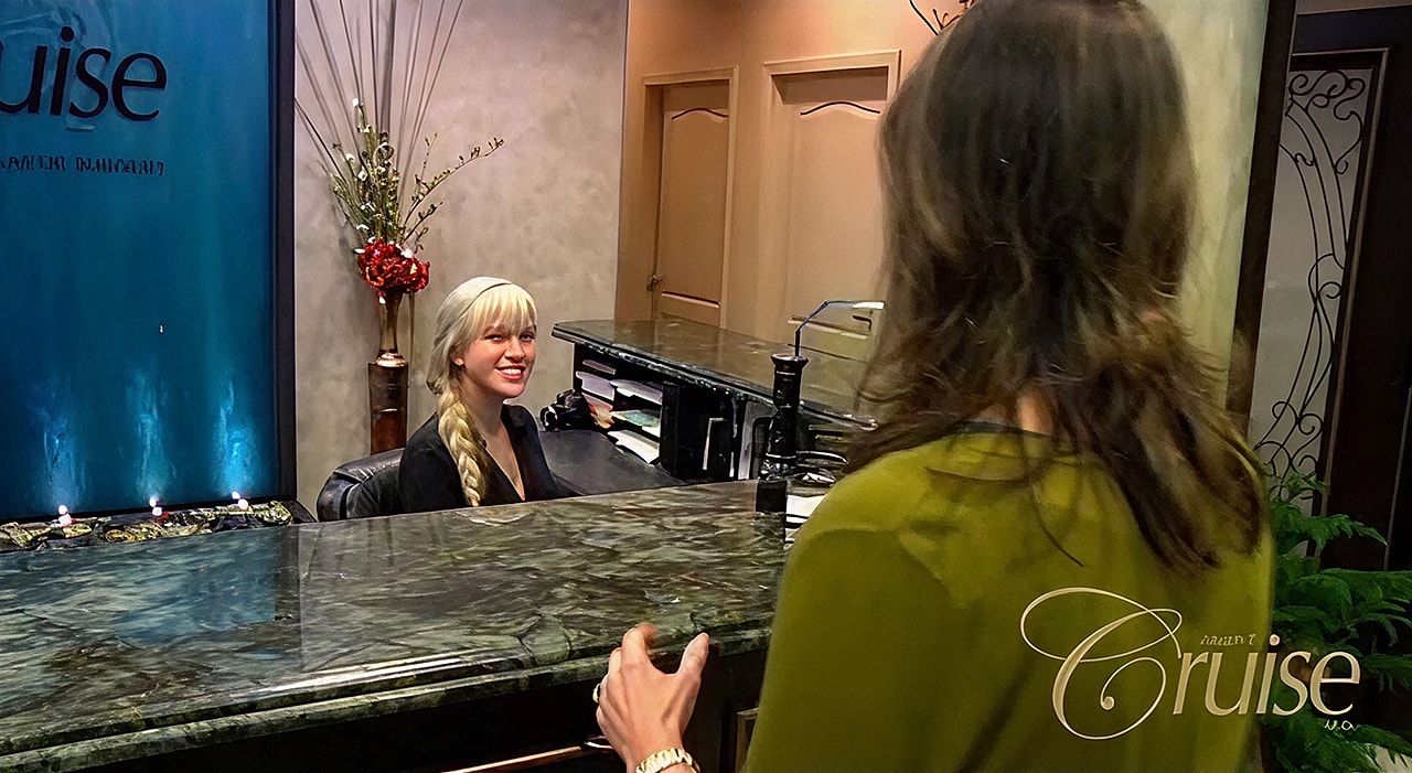 Reception area with smiling staff member.