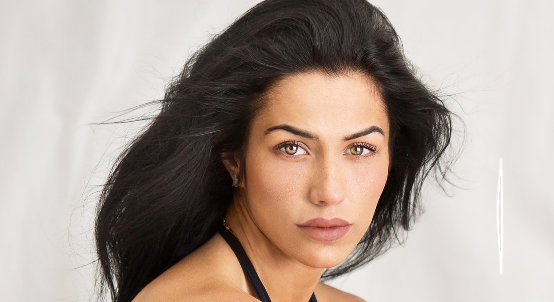 Close-up portrait of a woman with flowing hair.